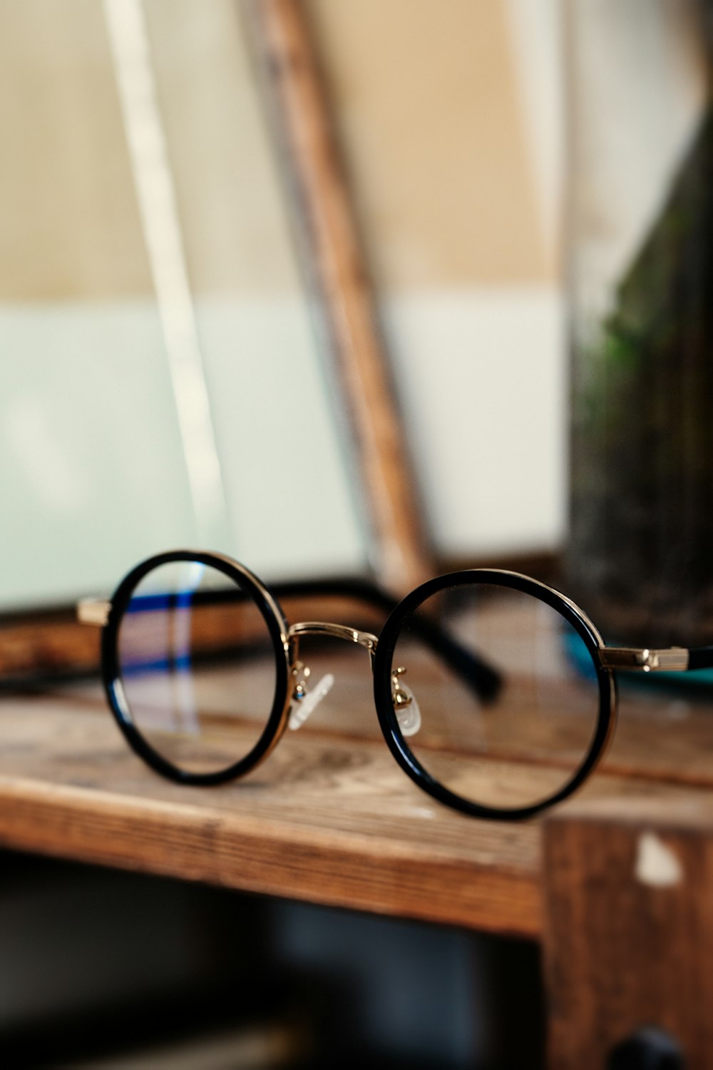 round black framed eyeglasses on table