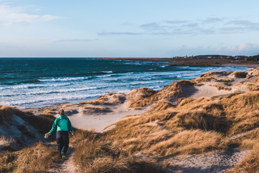 man walking near sea during daytime