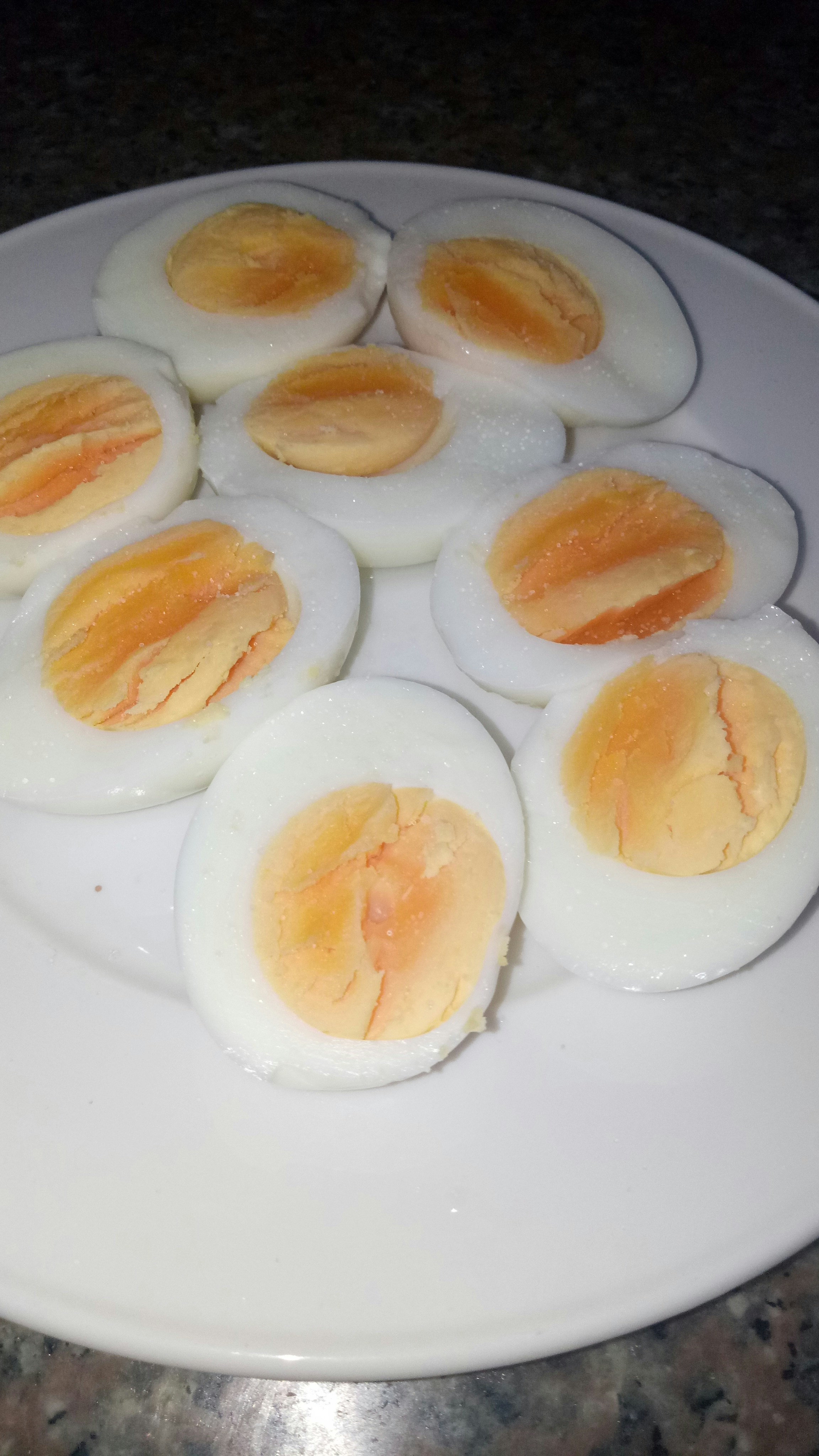 Halved boiled eggs on white plate