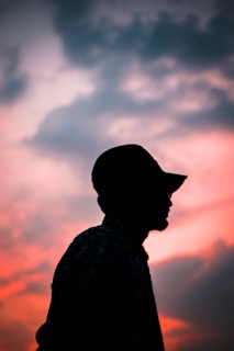 A sunset scene with a lone figure wearing the $wif hat, symbolizing unstoppable spirit.