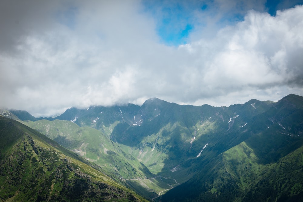 green mountains under white clouds during daytime