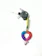 A keychain with a braided heart made of blue, purple, and pink threads is attached to a metal ring with two small silver bells. The braided portion is multicolored, transitioning through shades of blue, purple, and pink. It is connected to a loop of braided thread in yellow and green, from which keys are hanging.