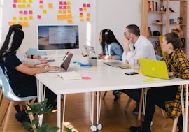 five person by table watching turned on white iMac