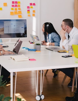 five person by table watching turned on white iMac