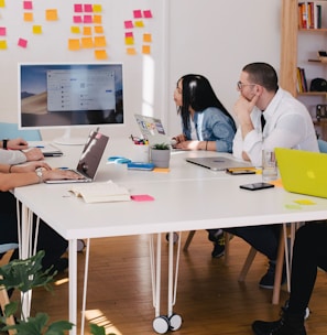 five person by table watching turned on white iMac