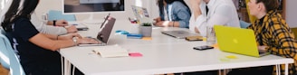 five person by table watching turned on white iMac