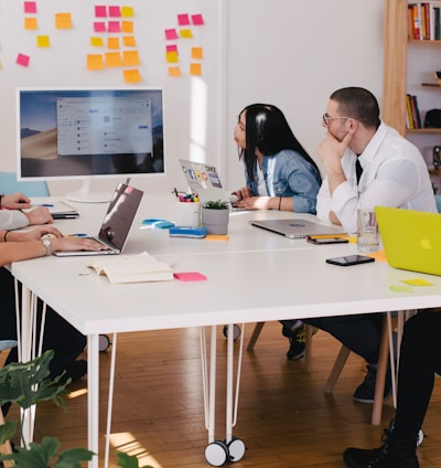 five person by table watching turned on white iMac