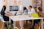 five person by table watching turned on white iMac
