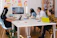 Team of professionals collaborating around a table with digital devices and notes