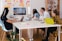 A team of diverse professionals collaborating on a project in a modern workspace.