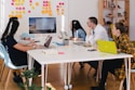 five person by table watching turned on white iMac