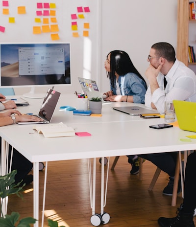 five person by table watching turned on white iMac