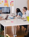 five person by table watching turned on white iMac