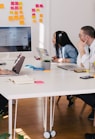 five person by table watching turned on white iMac