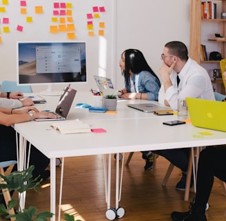 five person by table watching turned on white iMac