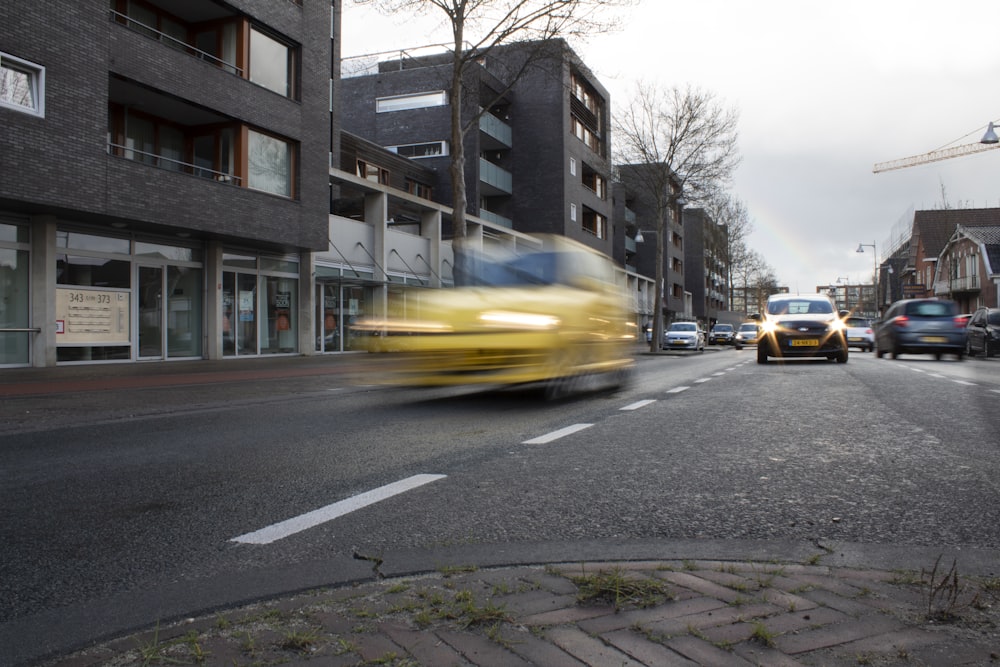 vehicles running on roadway during daytime