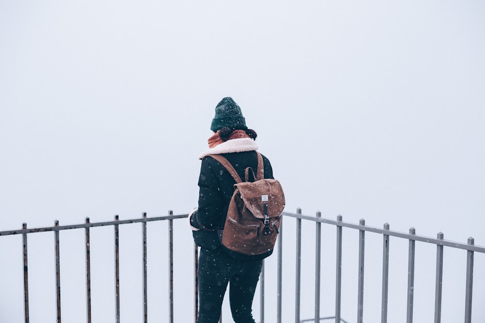 woman standing beside railling