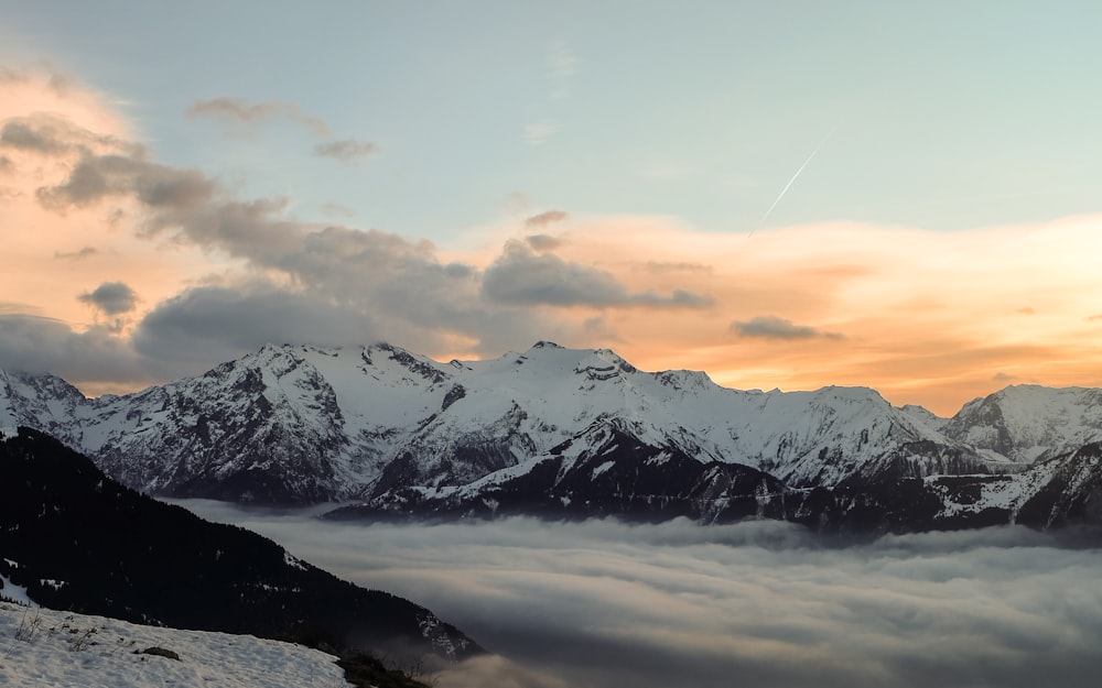 snow capped mountains during golden hour