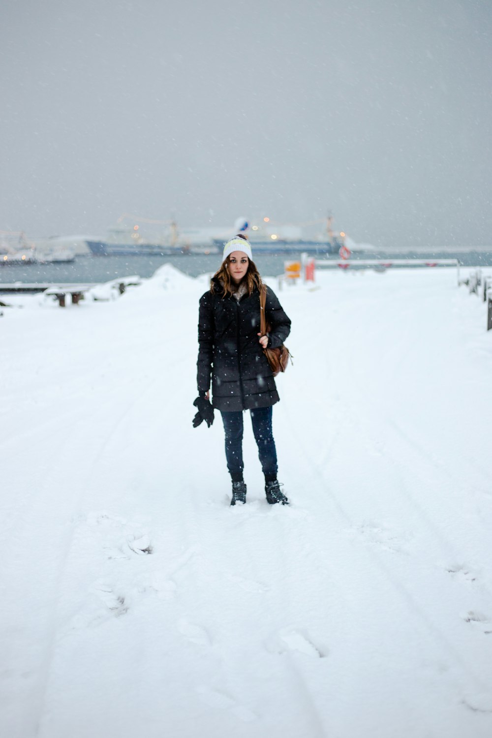woman standing on snowfield during daytime