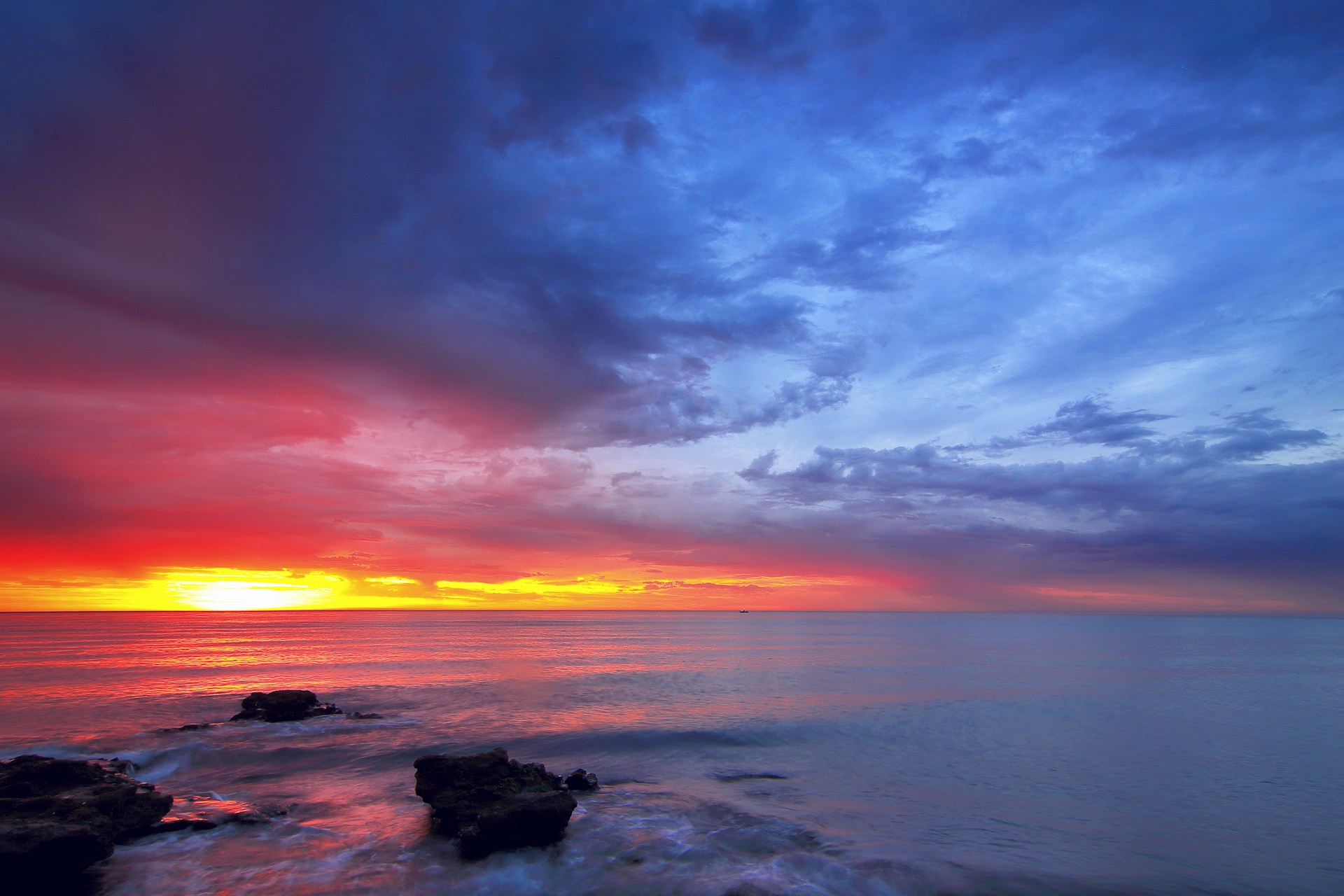 calm sea with rocks during golden hour