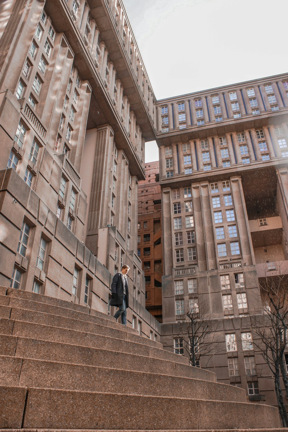 person walking down concrete stairs during daytime