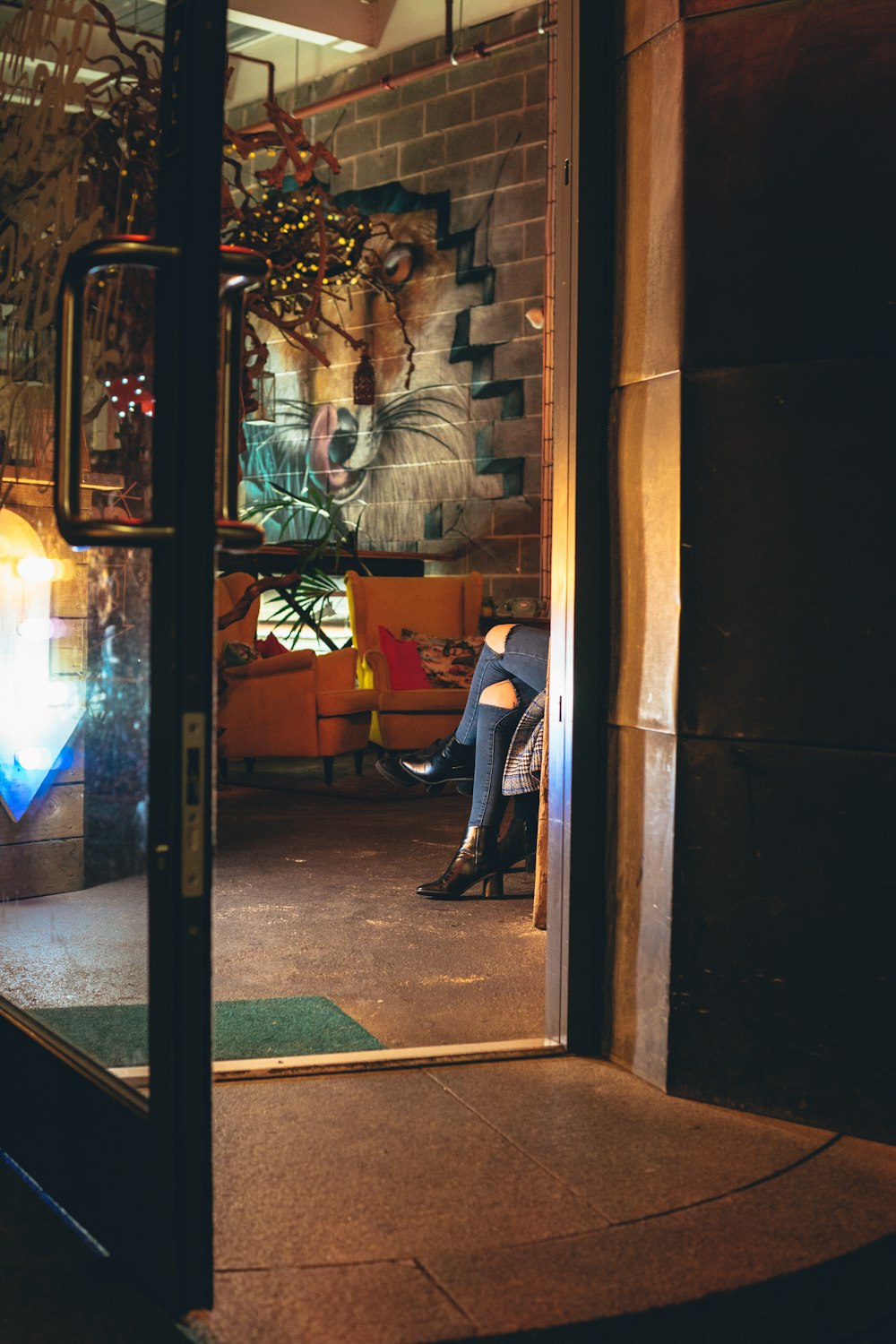 woman sitting by an glass doors is open