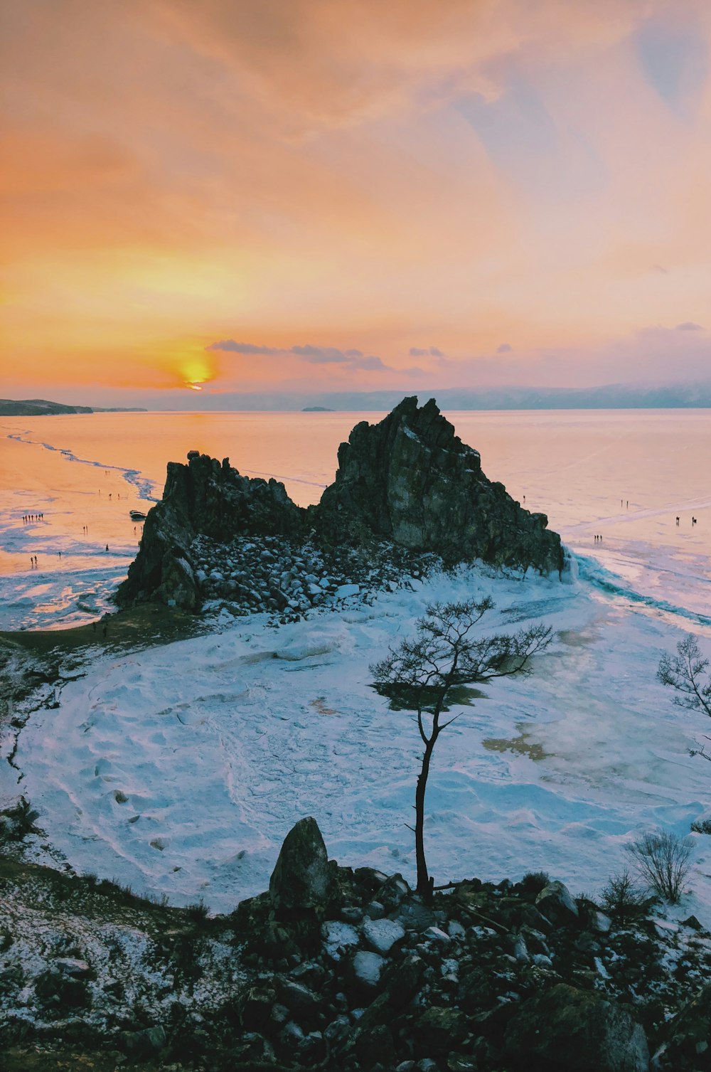 snow field covered mountains during golden hour