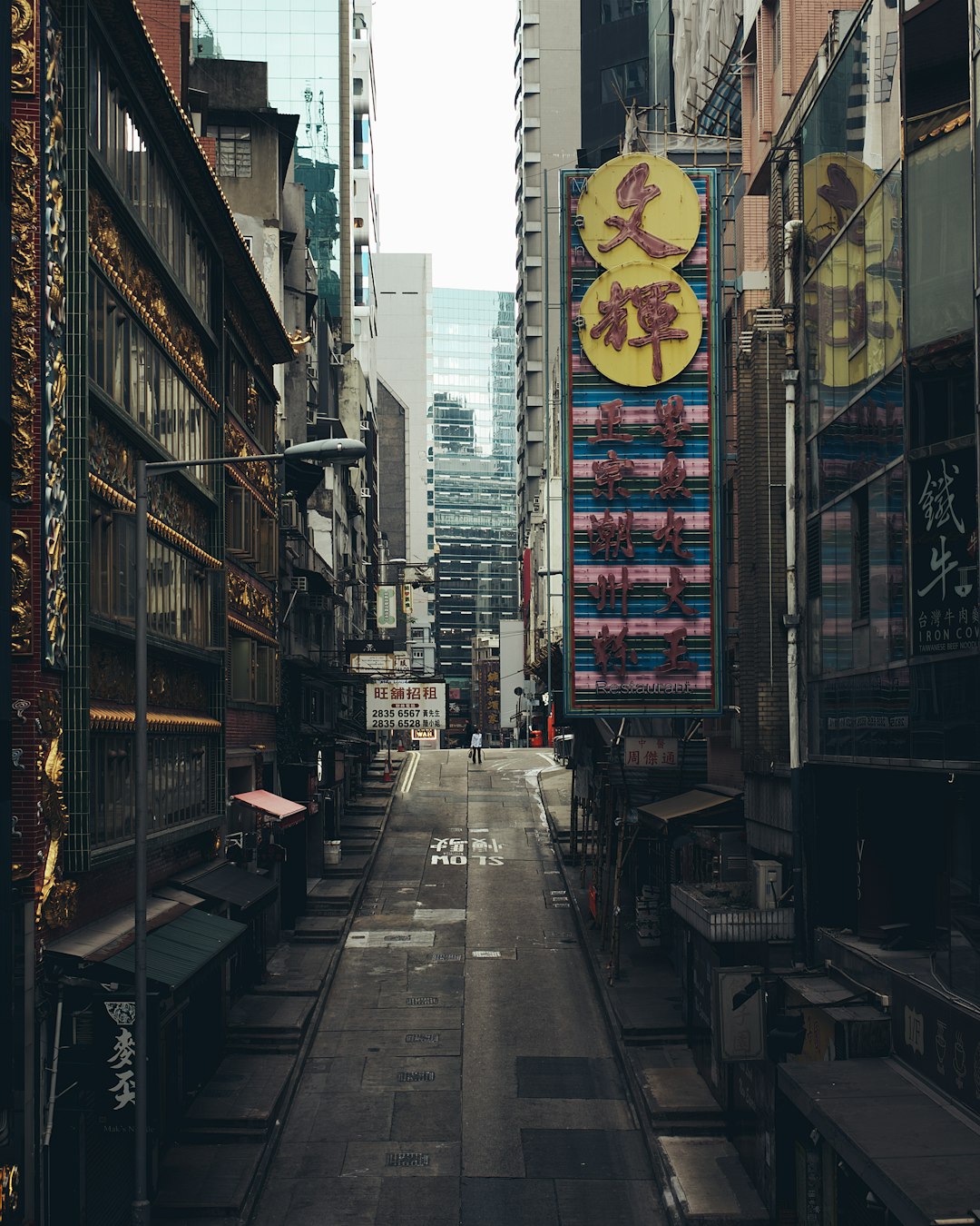 gray concrete road between buildings during daytime