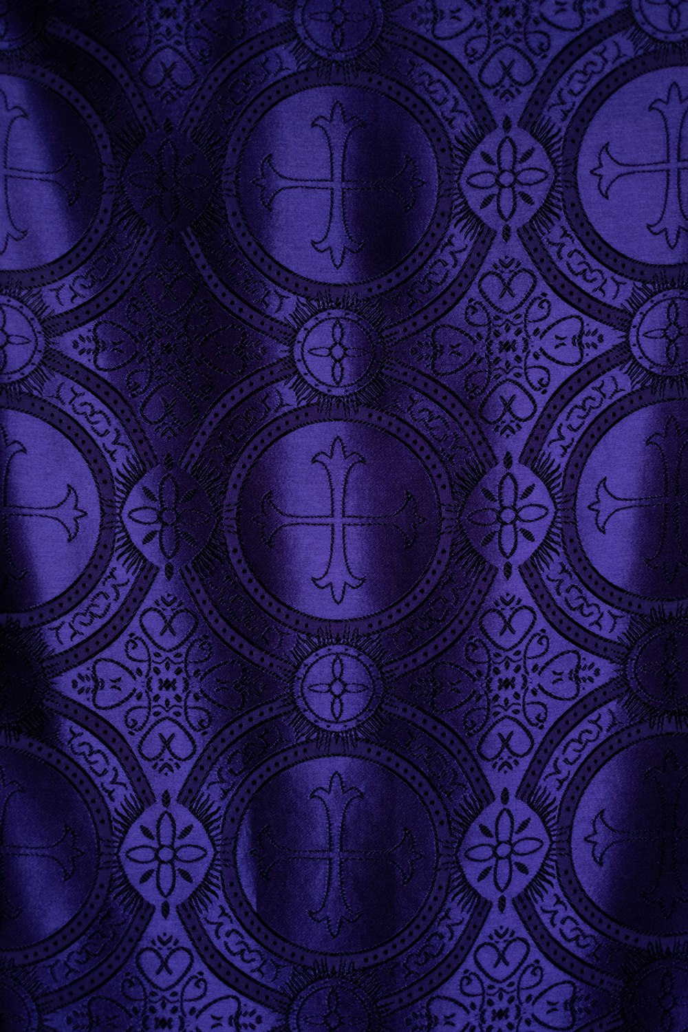 purple and white cross-print textile