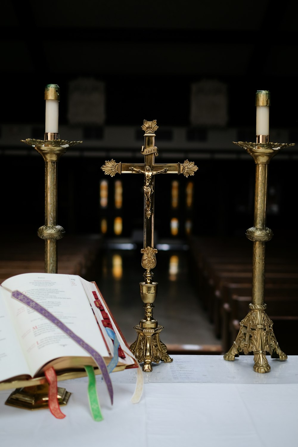 brass cross between candle holders