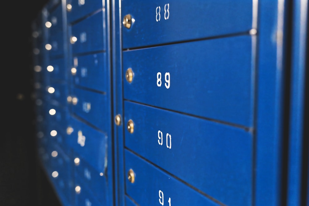 a close up of a blue mailbox with numbers on it