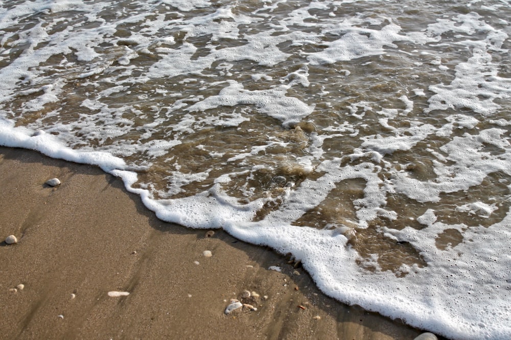 a close up of a wave on a beach