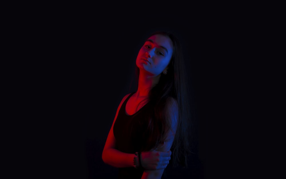 woman in black tank top in dark room