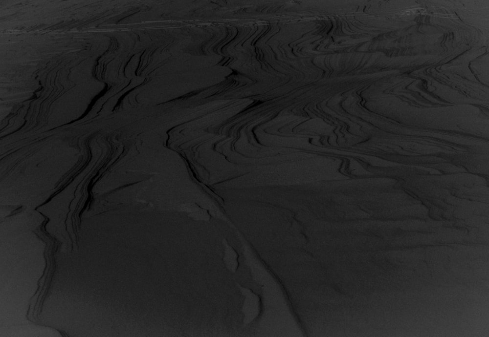 a black and white photo of a snow covered slope