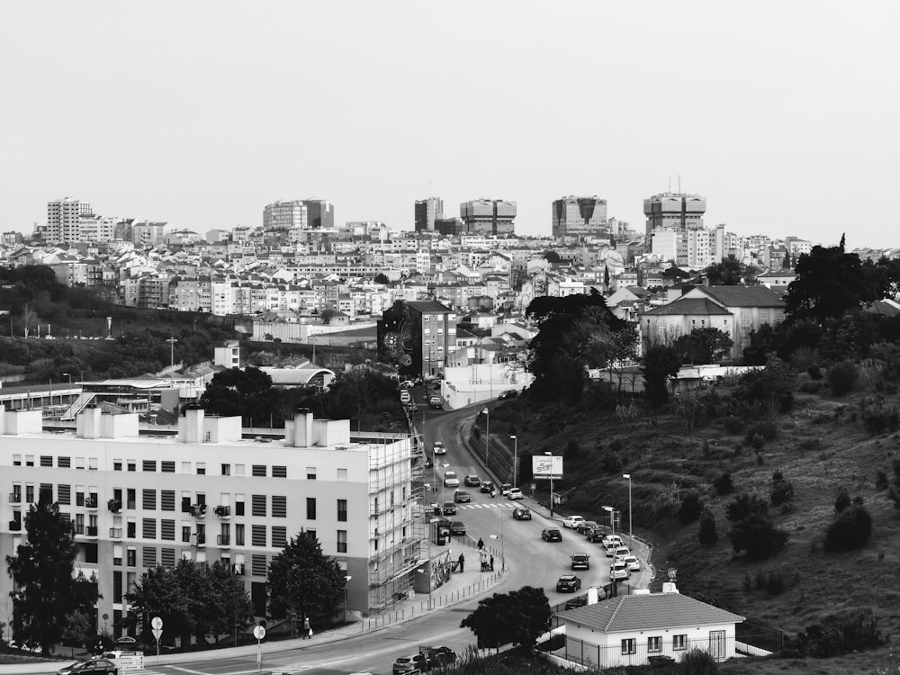 grayscale photo of buildings near trees