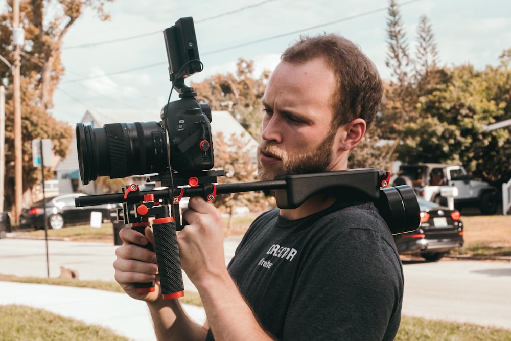 man holding camera during daytime