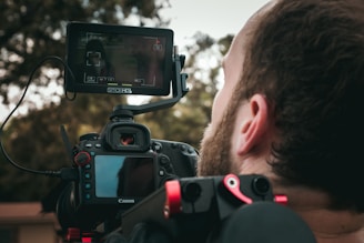 man taking photo using DSLR camera