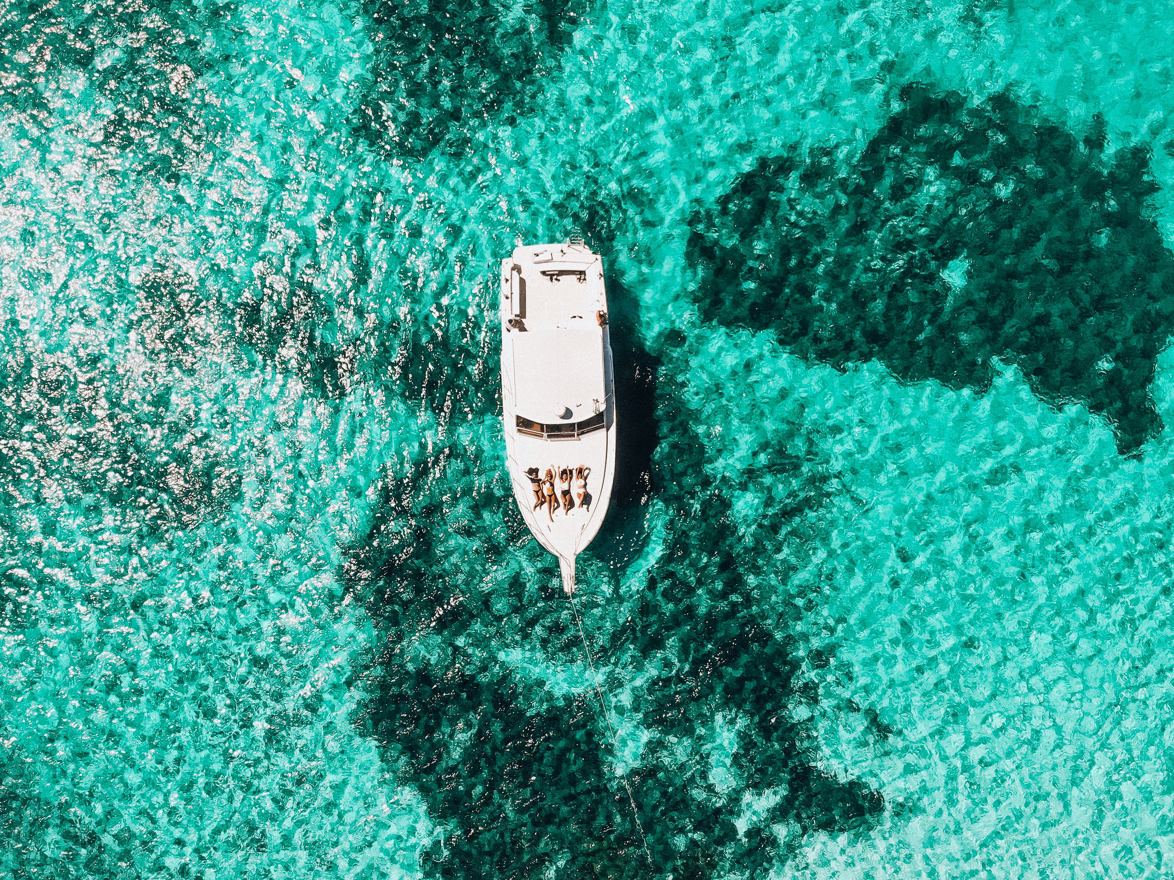 white yacht on body of water