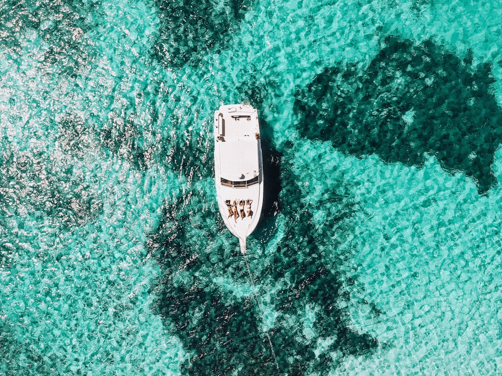 white yacht on body of water