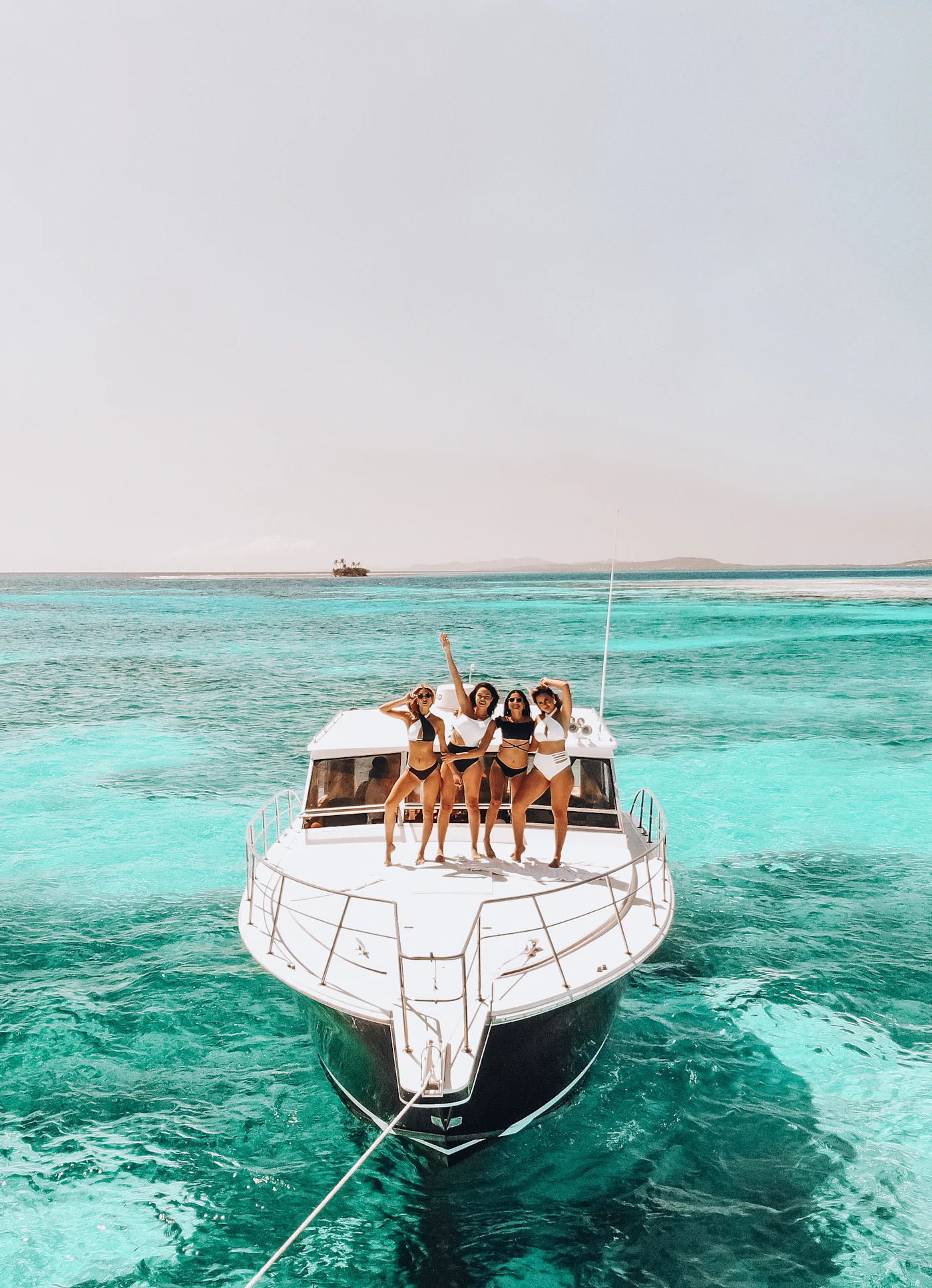 Party boat in Punta Cana: friends celebrating on a boat in turquoise water