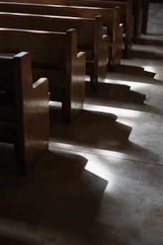 An old Quaker meeting house bathed in soft morning light, inviting quiet reflection.