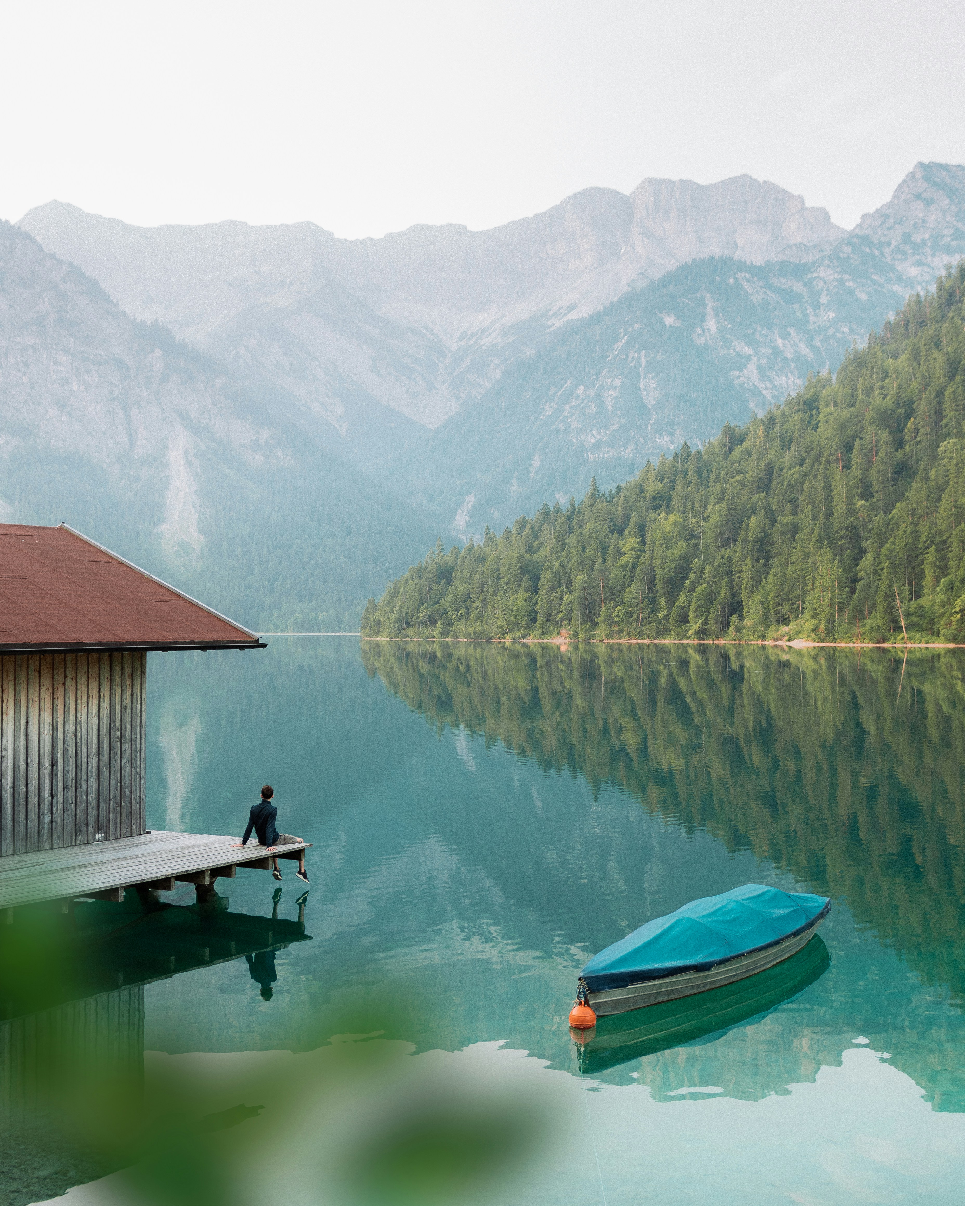 blue canoe on body of water during daytime