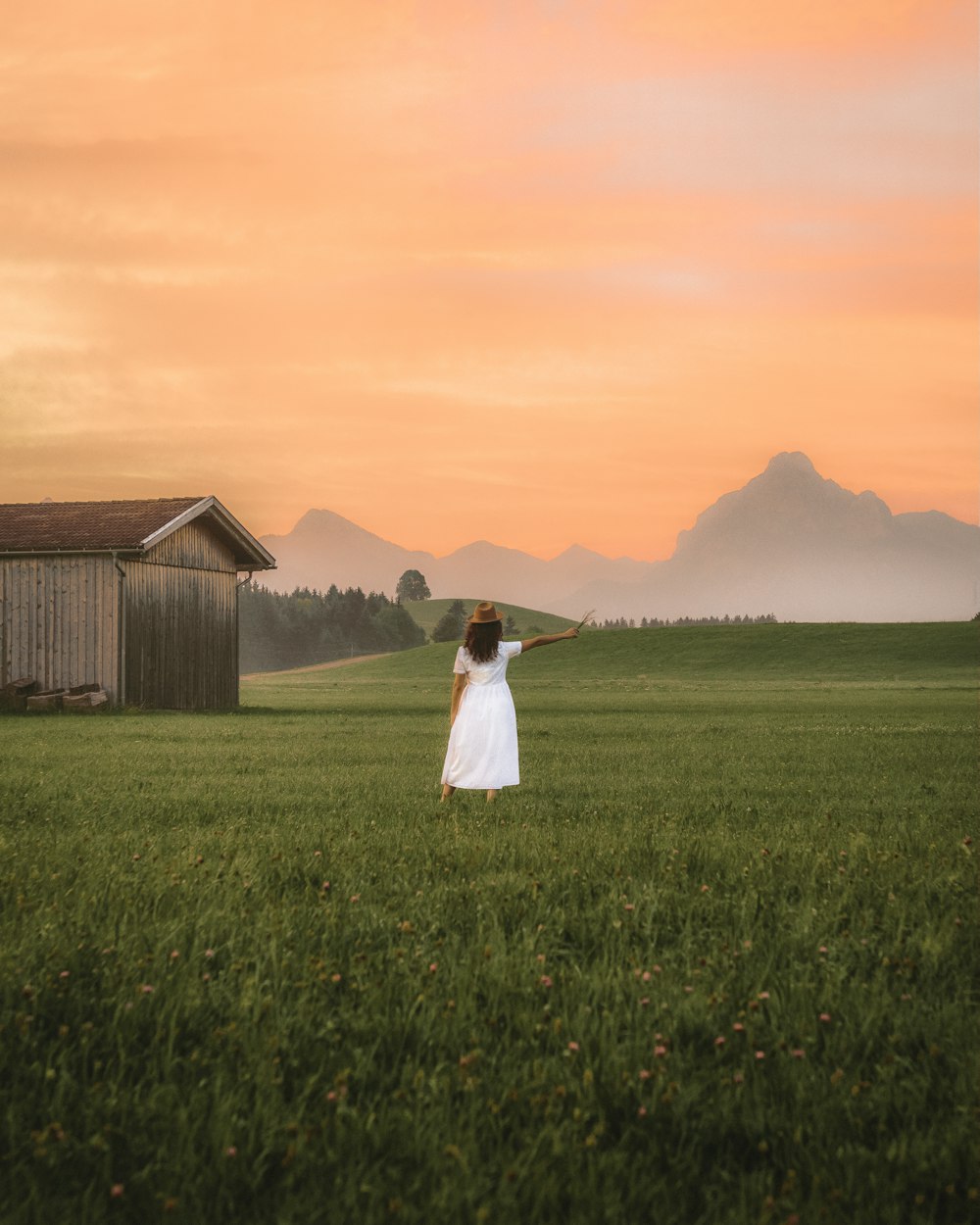 standing woman surrounded by plants during daytime