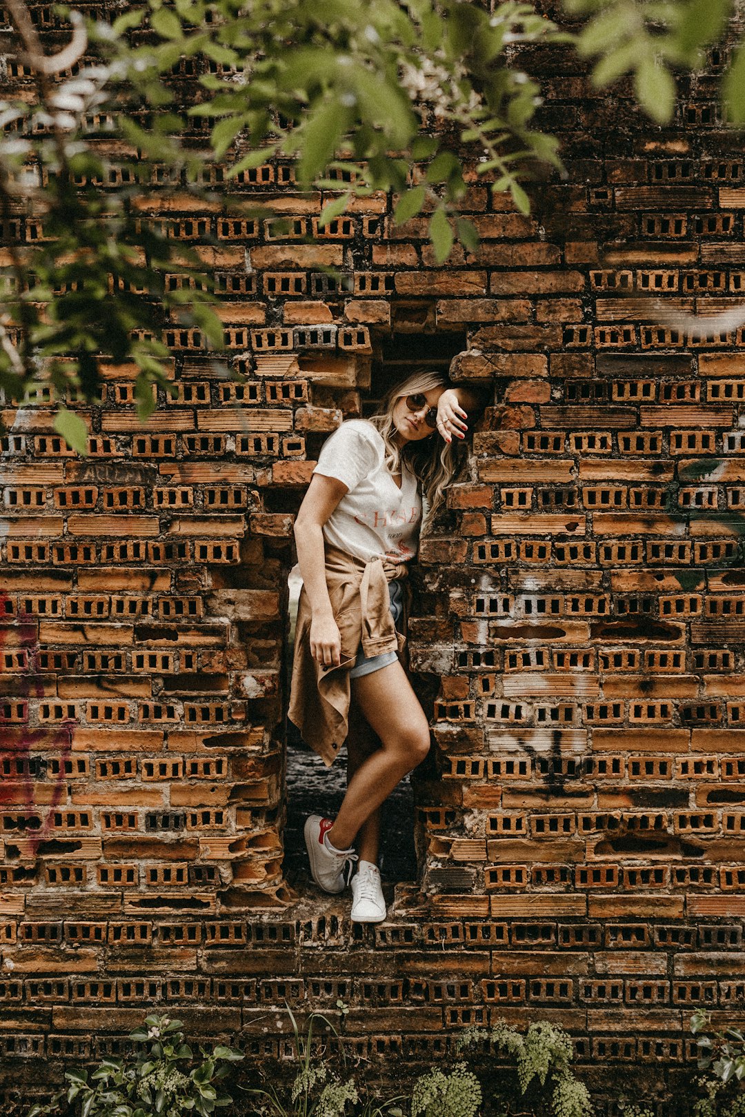 woman leaning on concrete bricks