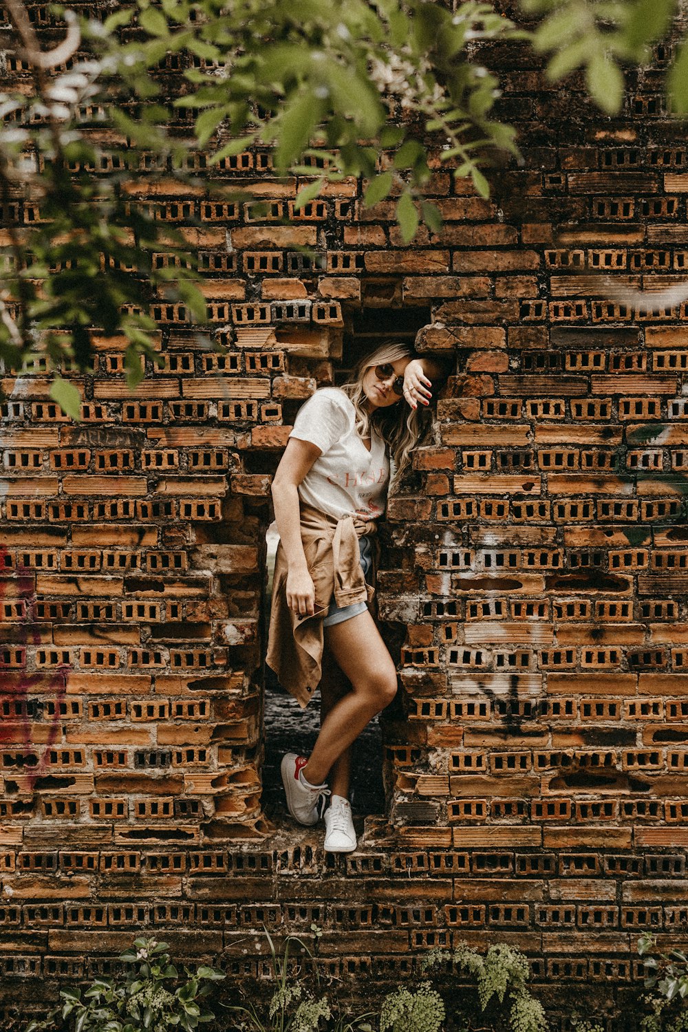 woman leaning on concrete bricks