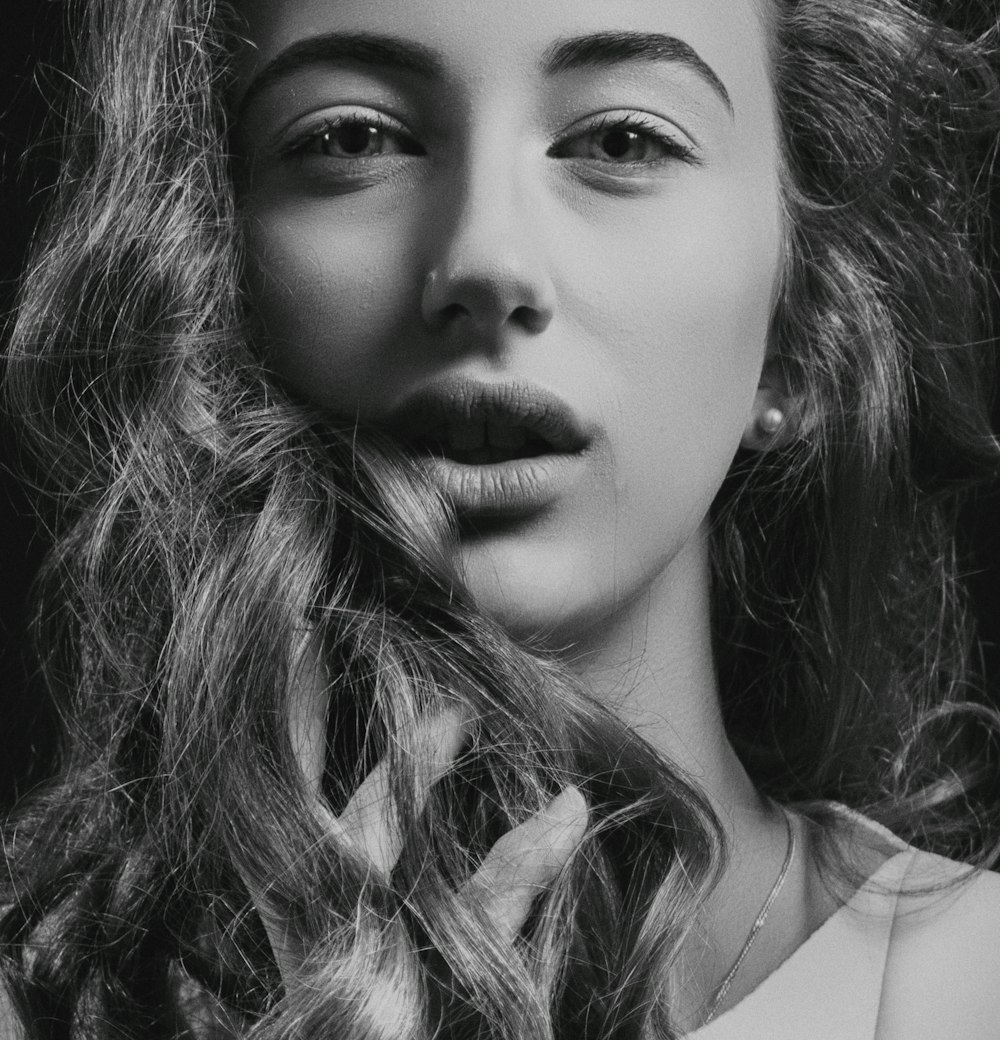 woman with curly hair in greyscale portrait photography