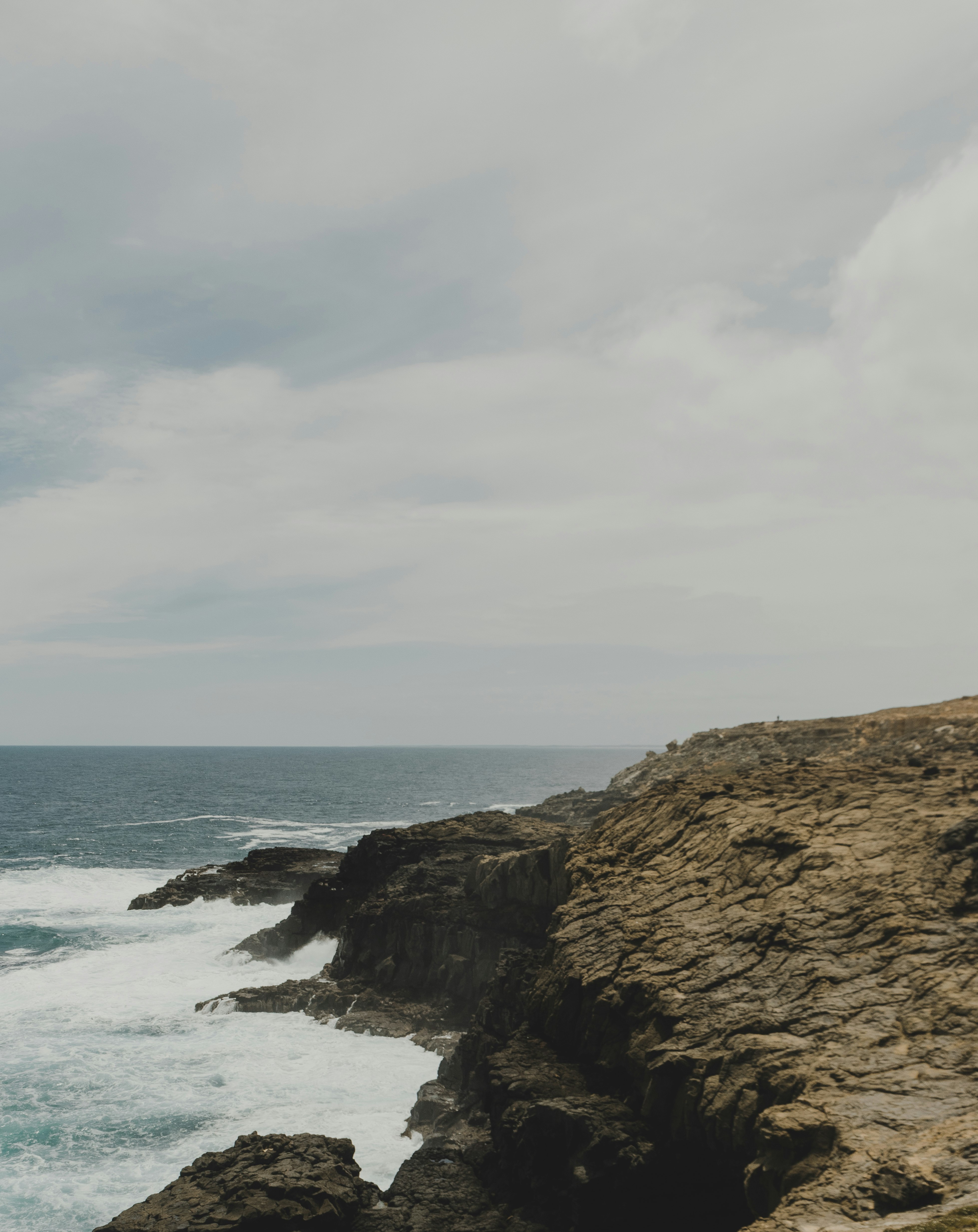 rock formation and ocean during daytime