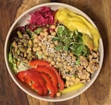 Healthy colorful salad bowl with fresh vegetables and nuts.