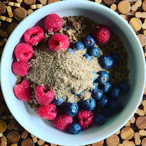 Close-up of a colorful high-protein breakfast bowl with fresh berries and nuts.