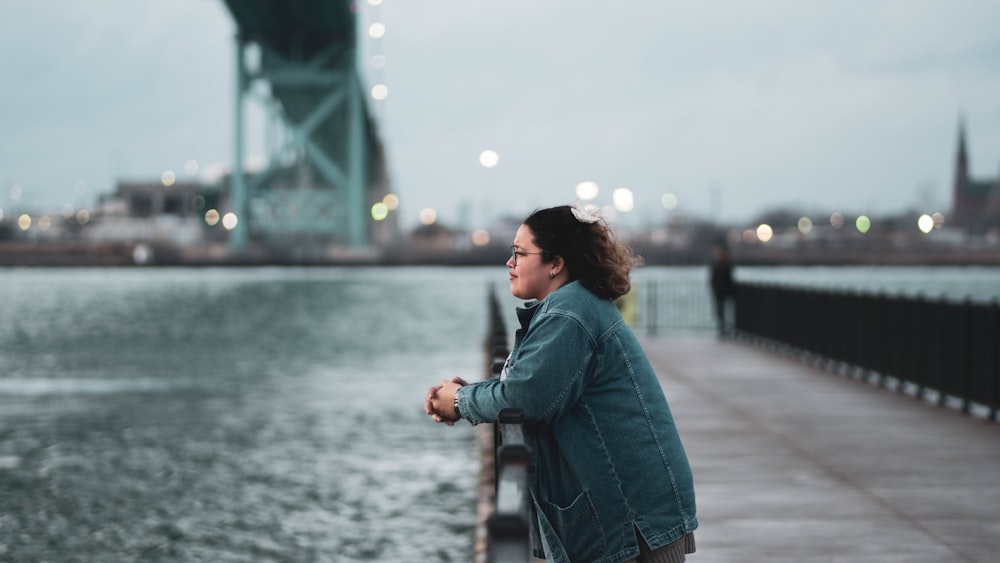 woman leaning on fence